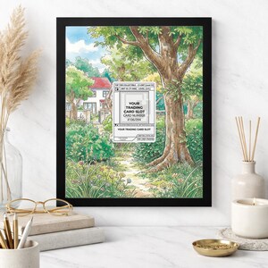 May include: An 8x10 inch framed print featuring a watercolor illustration of a path leading to a house, surrounded by trees and greenery. The frame is black, and the print includes text that reads "YOUR TRADING CARD SLOT".