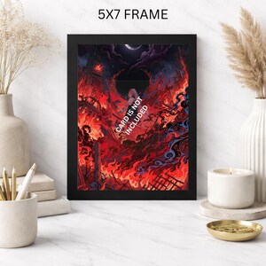May include: A black 5x7 frame displays a vibrant, fiery illustration. The artwork depicts a city engulfed in flames under a dark sky with a crescent moon. Text on the artwork reads "CARD IS NOT INCLUDED".