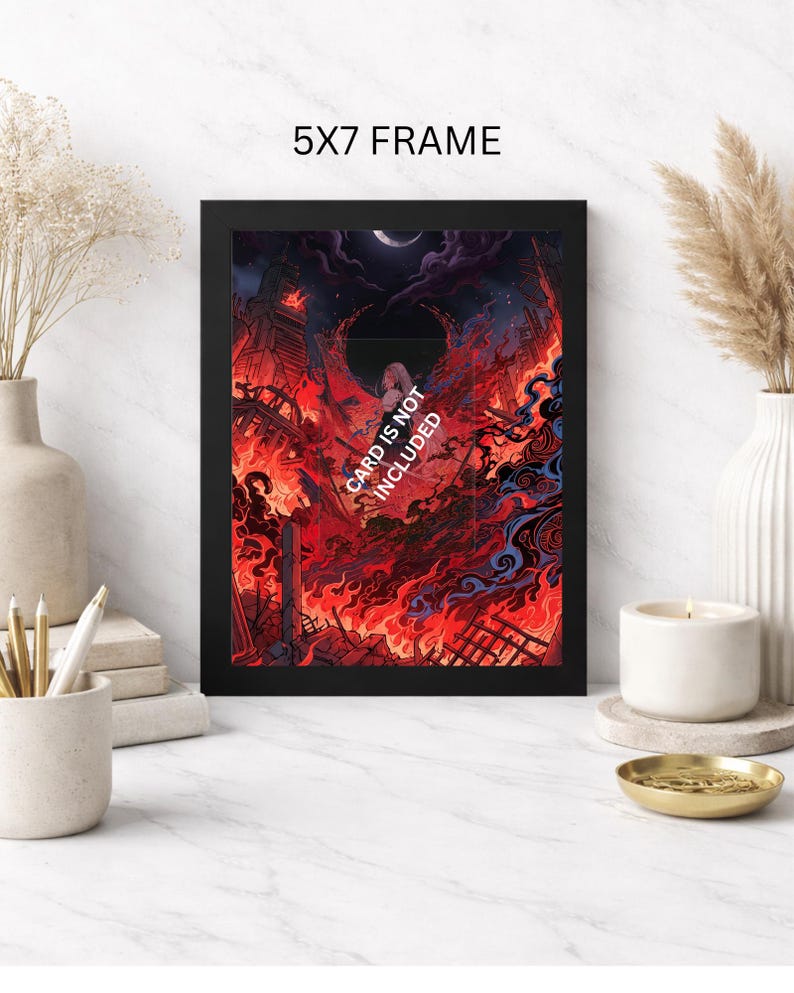 May include: A black 5x7 frame displays a vibrant, fiery illustration. The artwork depicts a city engulfed in flames under a dark sky with a crescent moon. Text on the artwork reads "CARD IS NOT INCLUDED".
