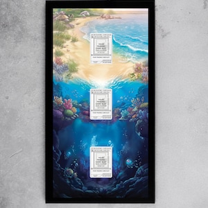 Puede incluir: Una obra de arte enmarcada que presenta una escena de playa que se transforma en una vista submarina. La obra de arte tiene tres ranuras para tarjetas coleccionables. La escena de la playa muestra arena, agua y cielo. La escena submarina tiene corales, peces y burbujas. Cada ranura tiene el texto "YOUR TRADING CARD SLOT".