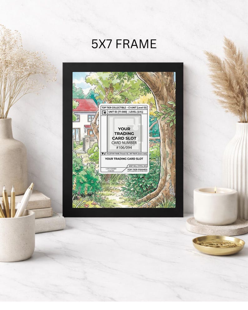 May include: A black 5x7 frame displaying a colorful illustration of a house and a path through a forest. The frame holds a trading card slot with the text "YOUR TRADING CARD SLOT" and card number #106/094.