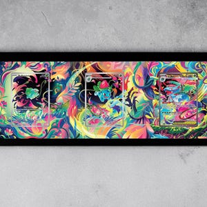 May include: A framed artwork featuring three Pokémon trading cards. The cards are set against a vibrant, colorful background with floral and abstract designs. The frame is black, and the overall aesthetic is eye-catching and artistic.