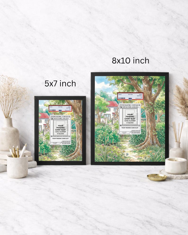 May include: Two framed art prints, one 5x7 inches and the other 8x10 inches, featuring a detailed landscape scene with trees, houses, and text that reads "YOUR TRADING CARD SLOT CARD NUMBER #106/054". The frames are black.
