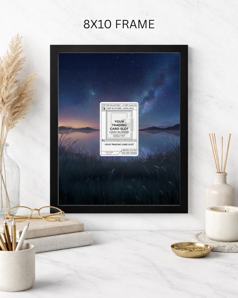 May include: Black 8x10 frame with a landscape print of a lake and starry night sky. A white card with the text "YOUR TRADING CARD SLOT" and "CARD NUMBER #202/197" is in the center. The frame is on a white surface.