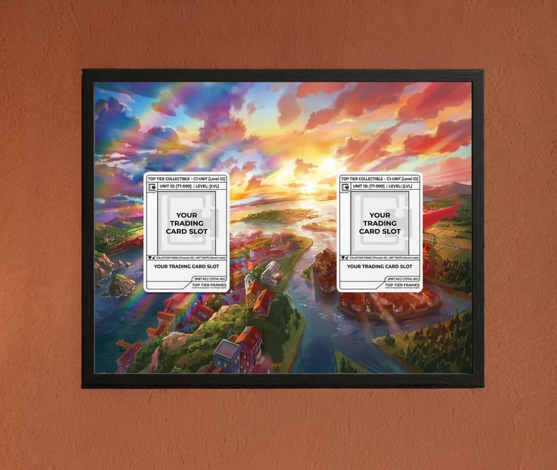 May include: Framed artwork featuring a vibrant landscape with a colorful sky and a river running through a town. Two white rectangles with text, "YOUR TRADING CARD SLOT", are overlaid on the image. The frame is black.