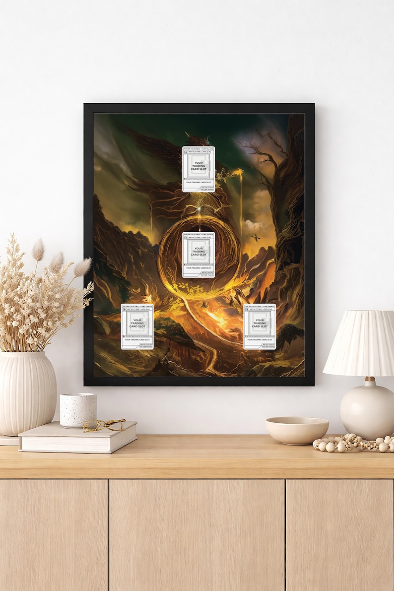 May include: A framed fantasy art print featuring a fiery landscape with a glowing portal. Several trading card slots are overlaid on the artwork. The print is displayed on a wooden cabinet with decorative items.