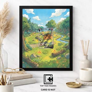 Può includere: Cornice nera 8x10 con un'illustrazione colorata di una scena di foresta, un fiume e una carta Pokemon. Il testo "CARD IS NOT INCLUDED" è visibile. La cornice è esposta su una superficie bianca con elementi decorativi.