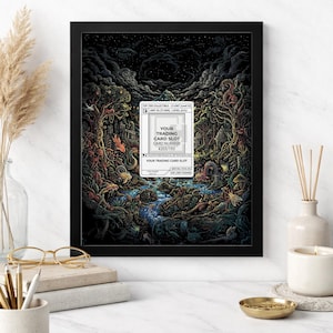 May include: An 8x10 framed art print featuring a detailed fantasy landscape with a river, trees, and creatures. The artwork includes a trading card slot with the text "YOUR TRADING CARD SLOT" and "CARD NUMBER #203/193". The frame is black.