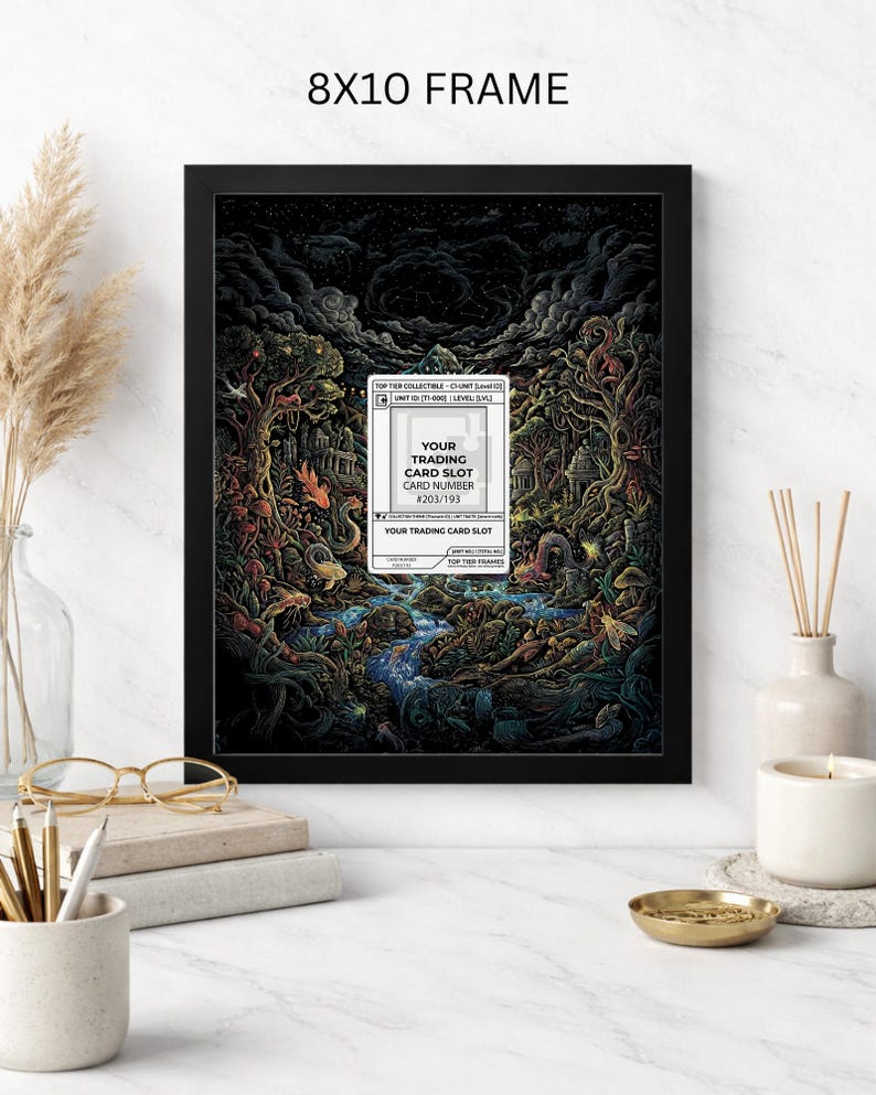 May include: An 8x10 framed art print featuring a detailed fantasy landscape with a river, trees, and creatures. The artwork includes a trading card slot with the text "YOUR TRADING CARD SLOT" and "CARD NUMBER #203/193". The frame is black.
