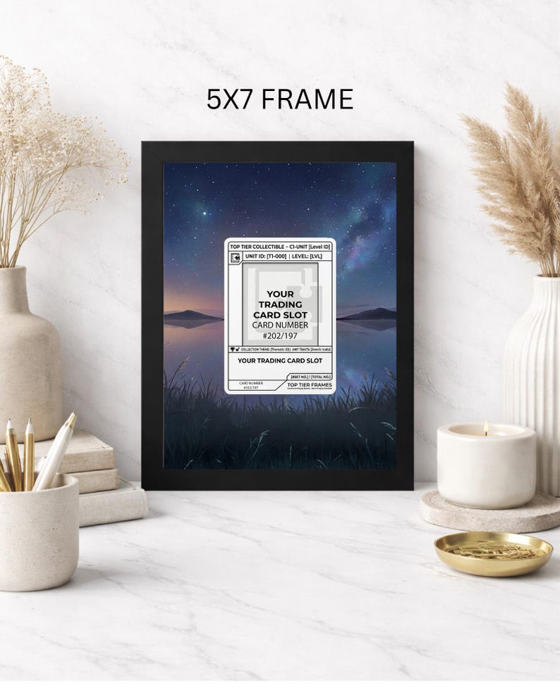 May include: A black 5x7 frame displaying a trading card slot with the text "YOUR TRADING CARD SLOT CARD NUMBER #202/197". The background features a scenic landscape with a starry sky and water. The frame is on a white surface.
