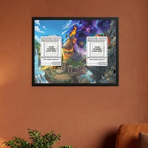 May include: Framed artwork featuring a fantasy landscape with waterfalls, mountains, and a volcano. Two white card slots are overlaid on the image, each labeled "YOUR TRADING CARD SLOT". The artwork is in a black frame.