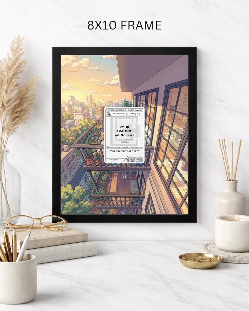 May include: Black 8x10 frame with an anime-style illustration of a cityscape at sunset. The artwork features a balcony with a trading card slot label. The frame is displayed on a white surface with decorative items.