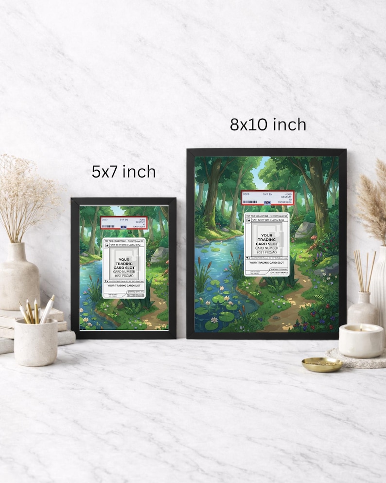 May include: Two framed prints, one 5x7 inches and the other 8x10 inches, featuring a serene forest scene with a stream. Each frame has a black border and includes a trading card slot label. The artwork depicts lush greenery and a tranquil water body.