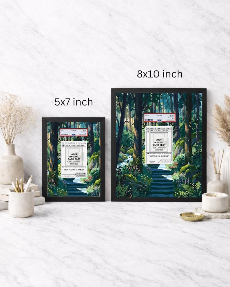 May include: Two framed art prints, 5x7 inches and 8x10 inches, feature a serene forest scene with a path. Each frame has a trading card slot label with text. The prints are displayed on a marble surface.