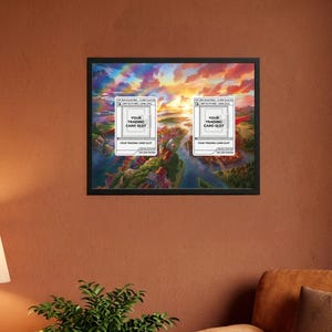 May include: Framed artwork featuring a vibrant landscape with a river and colorful sky. Two white card slots with the text "YOUR TRADING CARD SLOT" are overlaid on the image. The artwork is displayed in a black frame.