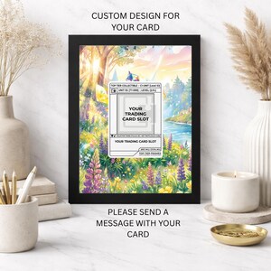 May include: A black 5x7 frame with the text "5X7 FRAME" and "CUSTOM DESIGN FOR YOUR CARD". The frame features a colourful landscape with a trading card slot. The text "PLEASE SEND A MESSAGE WITH YOUR CARD" is below the frame.