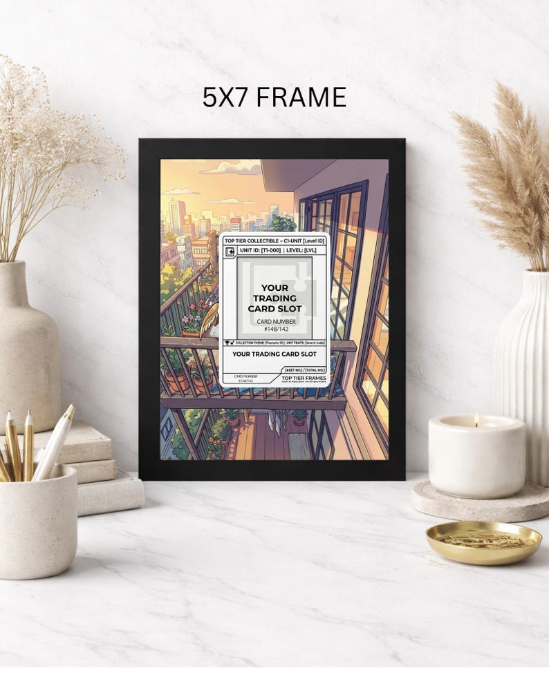 May include: A black 5x7 frame displaying a trading card slot design. The artwork features a balcony scene with a cityscape backdrop. Text includes "Your Trading Card Slot" and "Top Tier Frames."