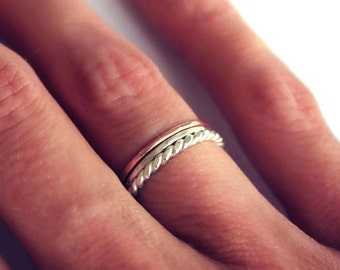 Set of three sterling silver and rose gold stacking rings, silver twist, rose gold and hammered.