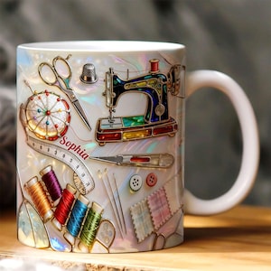 May include: White ceramic mug decorated with sewing tools, including a sewing machine, scissors, and spools of thread. The mug has a pearlescent finish and includes the name "Sophia" on a measuring tape. Other sewing tools are also depicted.