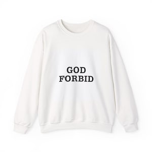 May include: Off-white sweatshirt with the text "GOD FORBID" in bold, black capital letters. The crew neck sweatshirt has long sleeves and a relaxed fit. The garment is made of a soft material.