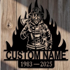 May include: Black metal wall art featuring a firefighter in gear, holding an axe, set against a backdrop of flames. The design includes the text "CUSTOM NAME" above the years "1983-2025".