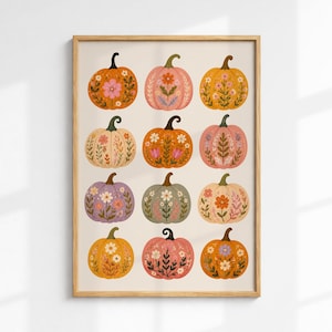 May include: A framed rectangular wall art print featuring a grid of twelve pumpkins in various colours including orange, pink, yellow, purple, and green. Each pumpkin is decorated with detailed floral patterns, leaves, and stems in a flat illustration style.