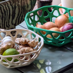 May include: A set of three ceramic mugs with a speckled, matte finish. The mugs are in shades of cream, light gray, and dark gray. Each mug has a simple, minimalist design, perfect for coffee or tea.