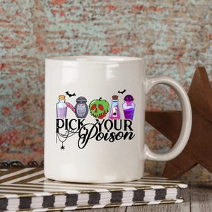 May include: White ceramic mug with a black handle featuring the phrase "Pick Your Poison" in a stylized font. The mug is decorated with colorful illustrations of potion bottles, a green skull, and bats, perfect for Halloween or spooky themes.