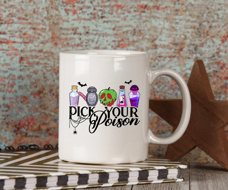 May include: White ceramic mug with a black handle featuring the phrase "Pick Your Poison" in a stylized font. The mug is decorated with colorful illustrations of potion bottles, a green skull, and bats, perfect for Halloween or spooky themes.