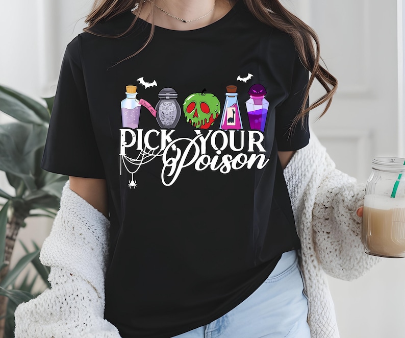 May include: Black t-shirt featuring a graphic with colorful potion bottles, bats, and a spiderweb. The text "PICK YOUR POISON" is displayed in white script. A Halloween-themed design.