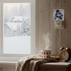 May include: A cozy winter scene with a snowman night light, a steaming mug, and a vintage alarm clock. The mug has a red and white pattern. A cable-knit blanket and a snowy landscape outside the window complete the warm, inviting atmosphere.