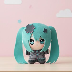 May include: A plush doll of an anime character with teal hair and a gray outfit. The doll has teal pigtails, gray cross-shaped hair accessories, and a pink background. The doll's outfit features a geometric design.