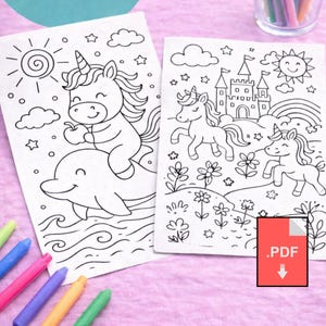 K&ouml;nnte beinhalten: Zwei Schwarz-Wei&szlig;-Malvorlagen mit Einh&ouml;rnern. Eine zeigt ein Einhorn, das einen Delfin reitet, die andere Einh&ouml;rner in der N&auml;he eines Schlosses und eines Regenbogens. Buntstifte in verschiedenen Farben sind sichtbar.