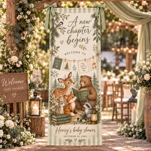 May include: A vertical banner with a light green striped border featuring the text A new chapter begins, Welcome to, and Henry's baby shower October 12, 2026. The illustration shows a deer, bear, fox, and raccoon in a forest setting.