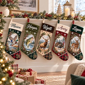 May include: Five personalized Christmas stockings hanging in a row. Each features a white cuff with a name: Mason, Harper, Wyatt, Avery, and Logan. The stockings display oval nature scenes including a duck, fish, elk, turkey, and deer.
