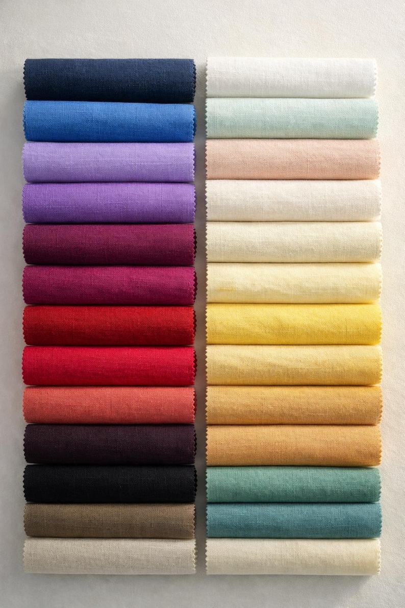 May include: A collection of rolled fabric samples in various colors. The left side features deep shades like navy, purple, and red. The right side showcases lighter hues, including cream, yellow, and teal. The fabric appears to be linen or a similar textured material.