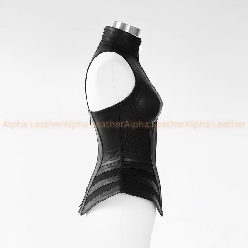 May include: A black leather corset with a high collar and a zipper closure. The corset has a structured design with horizontal and vertical panels, and a sleeveless design. The text "Alpha Leather" is visible in the background.