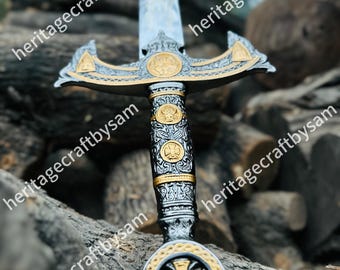 May include: An ornate sword with a silver blade and gold accents. The hilt features intricate designs and a cross emblem. The sword is displayed against a backdrop of wooden logs, showcasing its craftsmanship and historical aesthetic.