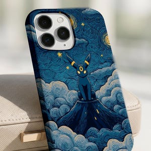 May include: A phone case featuring a dark blue design with a cartoon Umbreon character atop a mountain, set against a starry night sky. The case has a glossy finish and a protective bumper around the camera.