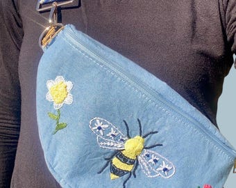 Fanny pack with hand-embroidered bee and flower.