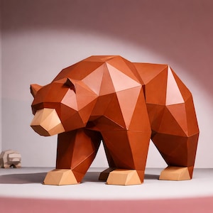 May include: A large, geometric brown bear sculpture with a tan snout and feet stands prominently, with a family of smaller, similar sculptures in the background. The bear is made of angular, flat planes, creating a modern, artistic aesthetic.