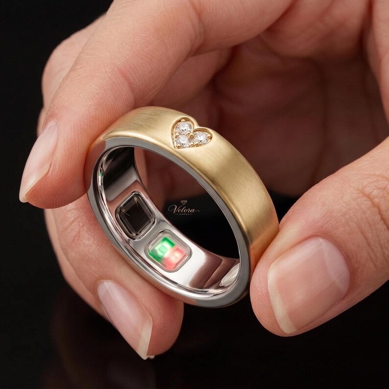 Handmade 14K Gold Smart Ring Protector Sleeve designed for Oura Ring Gen 5. Featuring a contemporary matte finish and sparkling diamond-cut accents, this decorative band cover combines advanced wearable technology with classic jewelry-inspired craftsmanship and luxurious detail.