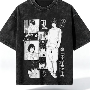 May include: Black graphic t-shirt featuring manga-style illustrations and the text "DEATH NOTE". The design includes multiple panels of manga art and a central character illustration. The shirt has a washed, vintage look.