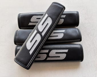 Almohadillas para cinturón de seguridad de cuero genuino, 4 unidades, color negro, acero inoxidable, bordado plateado