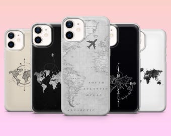 May include: A collection of five phone cases with travel-themed designs. The cases feature world maps, compasses, and airplane graphics in various colors, including black, white, and gray. The cases are displayed against a soft pink background.