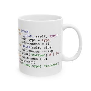 May include: A white ceramic mug featuring colourful Python programming code printed on the side. The code includes text such as class Drink, def __init__, self.ounces = 11, and print(f"{mug.type} Finished"), with syntax highlighting in blue, red, purple, and green.