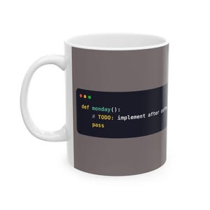 May include: A white ceramic mug featuring a dark grey rectangular graphic that displays computer code. The text reads: def monday(): # TODO: implement after coffee pass. The design includes three small coloured circles at the top left corner.