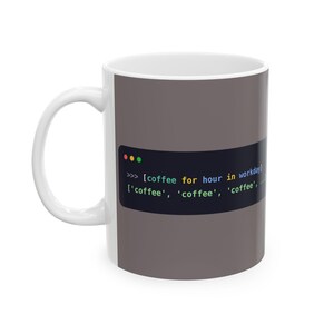 May include: A white ceramic mug featuring a dark gray rectangular graphic that displays a Python-style code snippet: >>> [coffee for hour in workday] ['coffee', 'coffee', 'coffee', ...]. The mug has a standard handle and a smooth, cylindrical body.