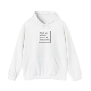 May include: White hooded sweatshirt with a front pocket and drawstring. The text "Think Like a Model. Build Like an Engineer." is printed in a gray square on the front. A casual, comfortable garment.