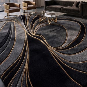 May include: A large area rug featuring a deep black and charcoal gray color palette with sweeping, curved gold-toned lines that create a fluid, organic pattern across the surface. The rug includes a circular logo in the corner reading Rowel Rugs.
